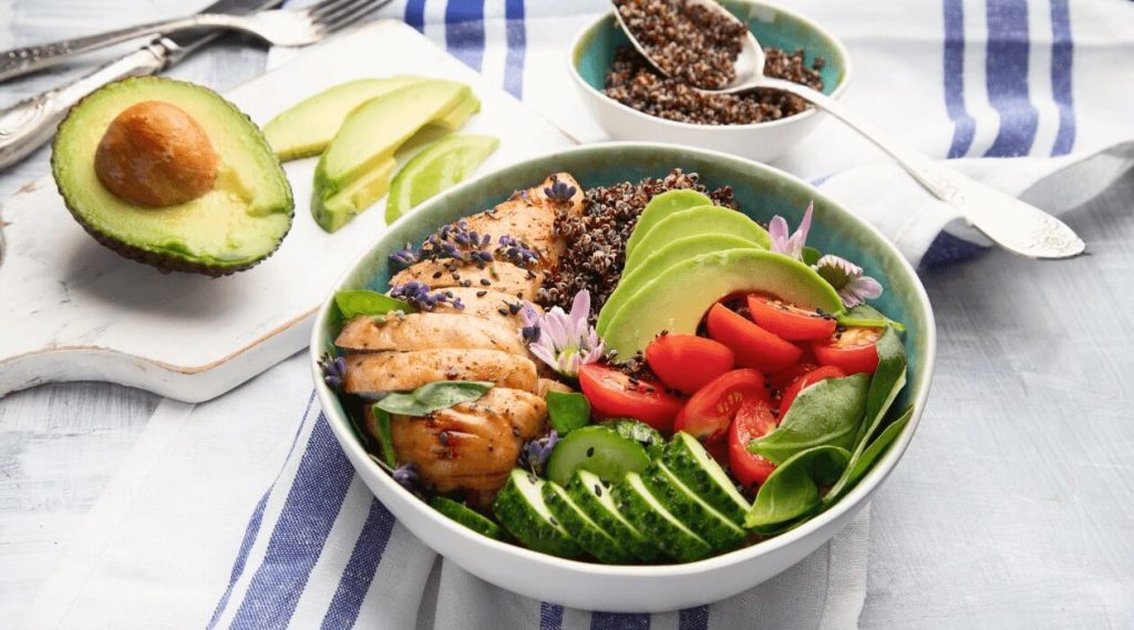 White bowl with quinoa chicken and vegetables